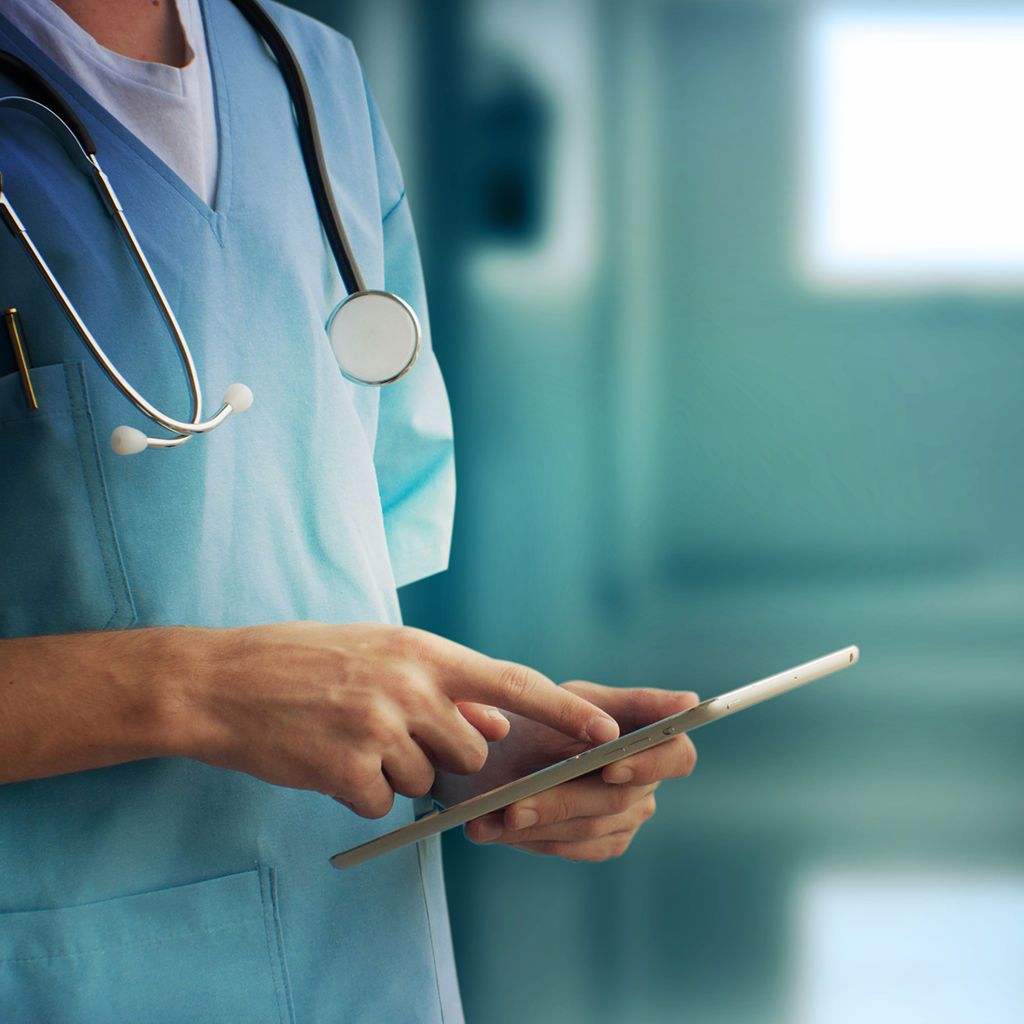 A nurse checking information on the tablet
