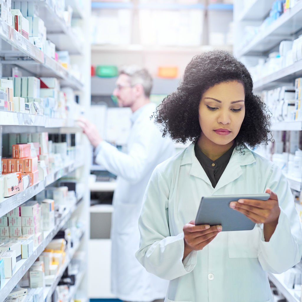 Two pharmacists searching for medicine in a medical storage room